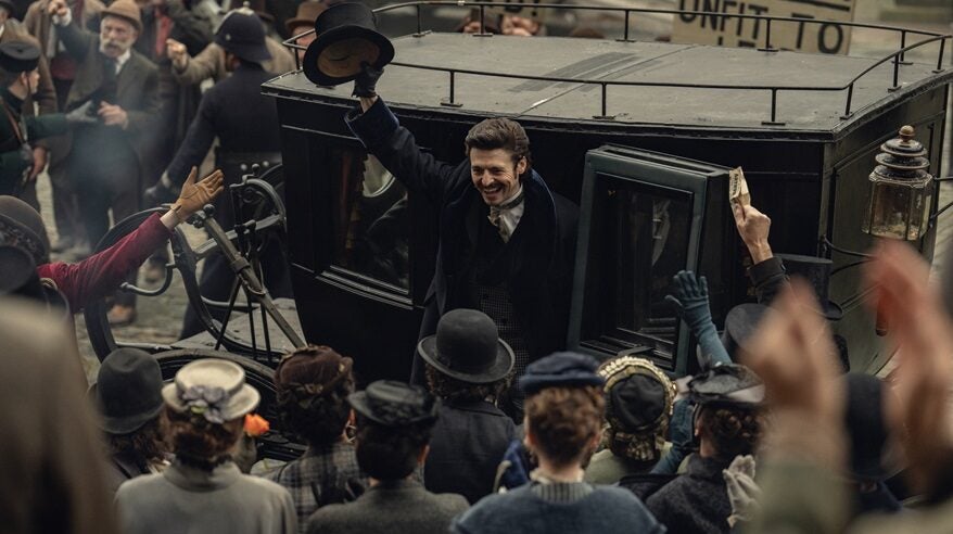 Period drama House of Guinness, with a man in 19th century costume getting out of a stagecoach and waving to a crowd