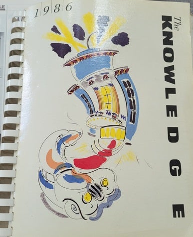 White cover of a spiral-bound books with multi-coloiured graphic and The Knowledge printed down the right hand side
