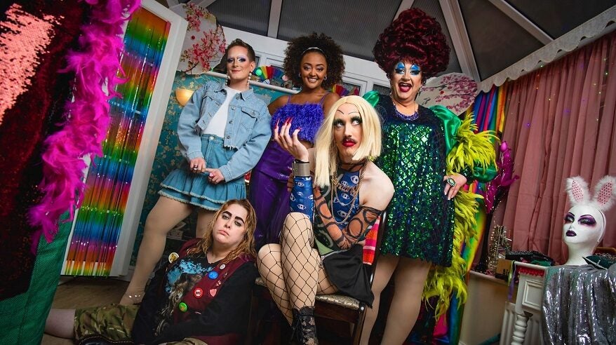 The cast of BBC comedy Smoggie Queens in full stage make-up and glittery costumes